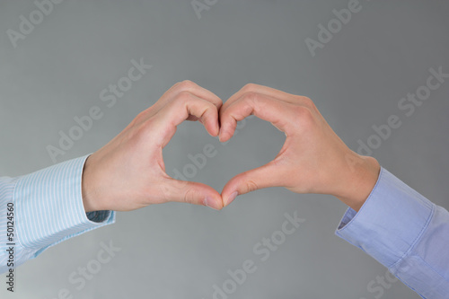 hands of man and woman forming a heart