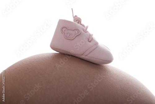 Vientre mujer embarazada con zapatitos photo