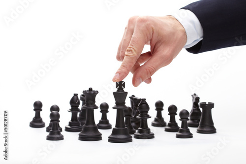 Business man moving chess figure