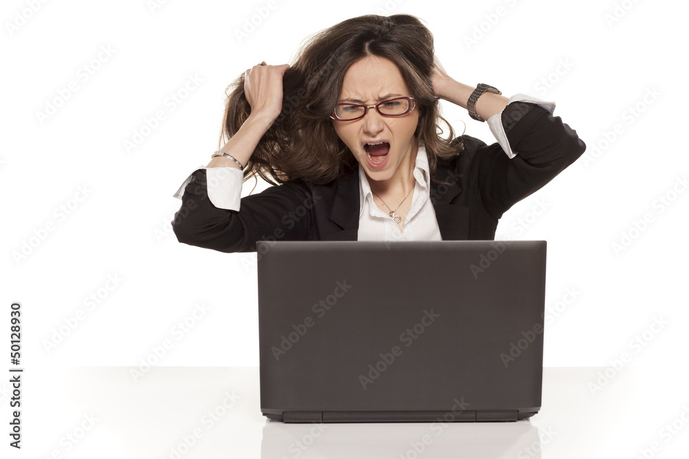 nervous girl on a laptop pulls her hair and screaming on white b nervous girl on a laptop pulls her hair and screaming on white b