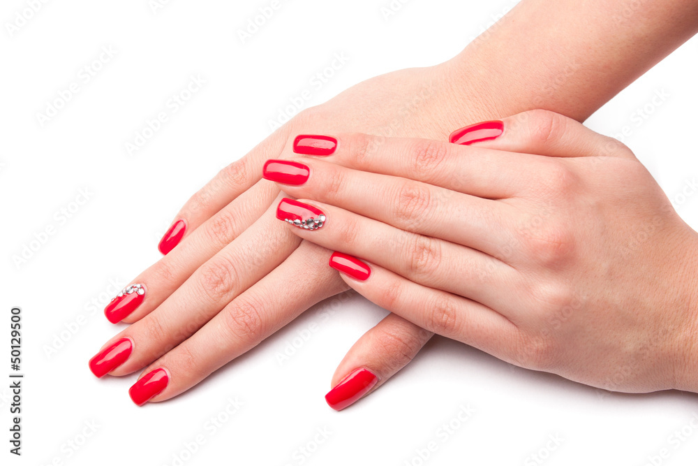 Beautiful female hand with red nails isolated on white Beautiful female hand with red nails isolated on white