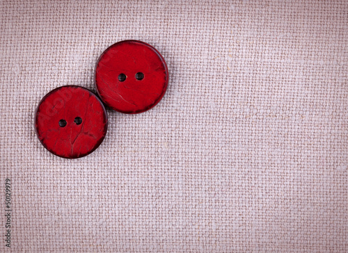 Obraz na plátne Two wooden red sewed buttons