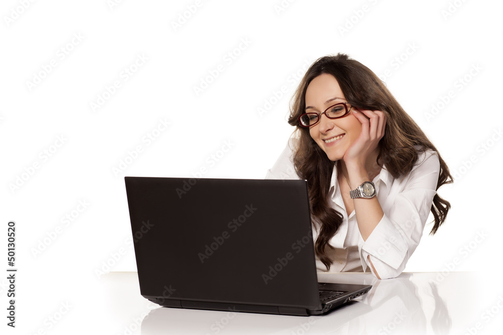 nice smiling girl communicating with someone on her laptop on wh nice smiling girl communicating with someone on her laptop on wh