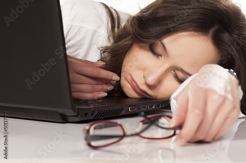 secretary sleeping on her laptop in the workplace on white backg