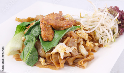 Asian stir fried flat rice noodles. Pad se ew with chicken. photo