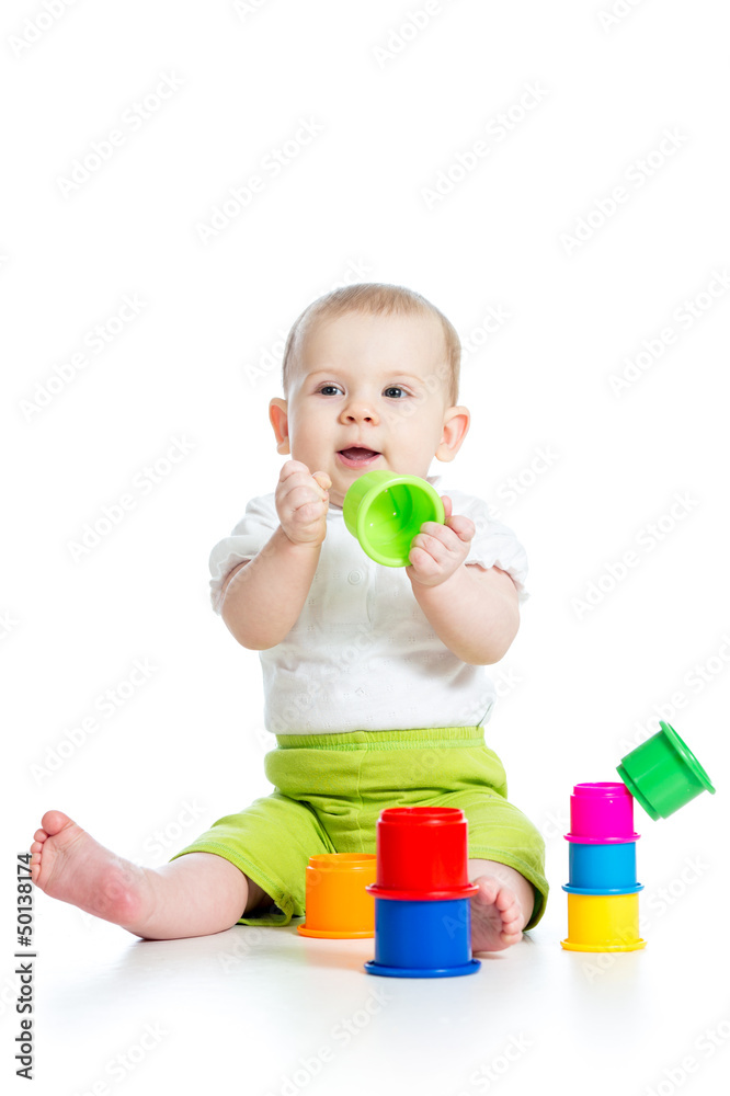 Funny little child playing with toys isolated over white Funny little child playing with toys isolated over white
