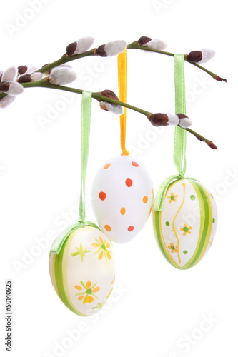 Colored easter eggs hanging from willow branches