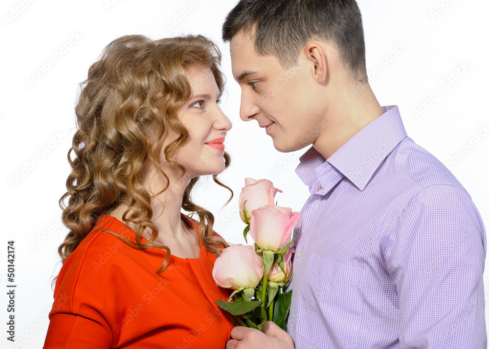 Closeup of young happy couple with pink roses Closeup of young happy couple with pink roses