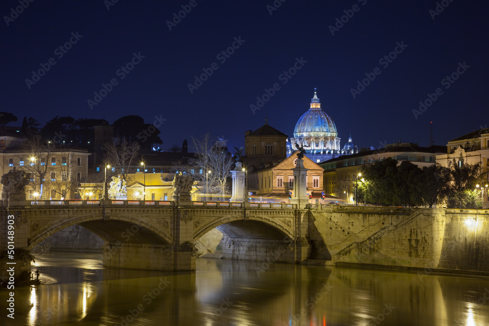 A beautiful view to St. Peter's basilica at night from the bridg