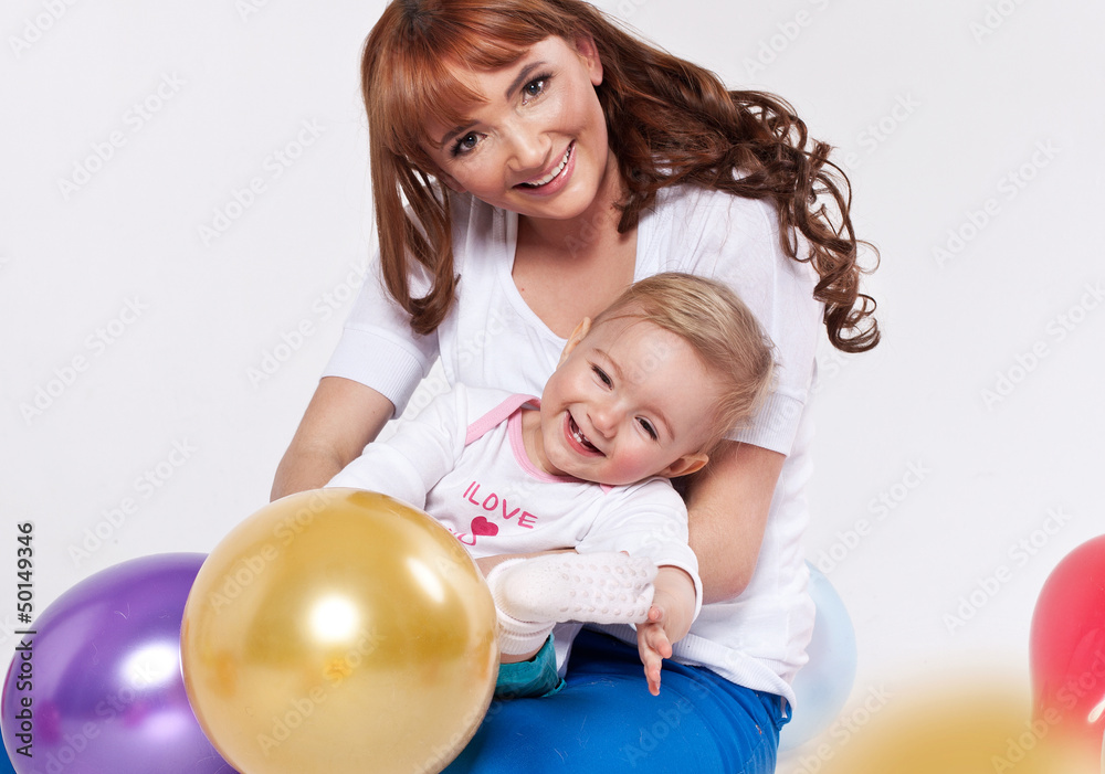 Beautiful smiling mum hugging her child Beautiful smiling mum hugging her child