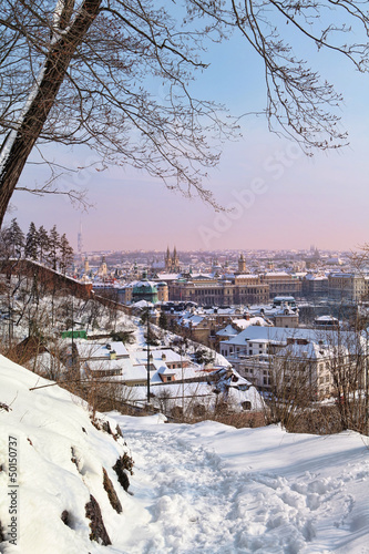 View of Prague's Old Town from Chotek gardens with snow