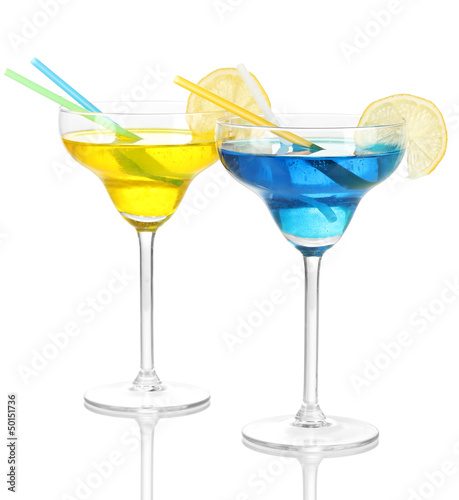 Yellow and blue cocktails in glasses isolated on white