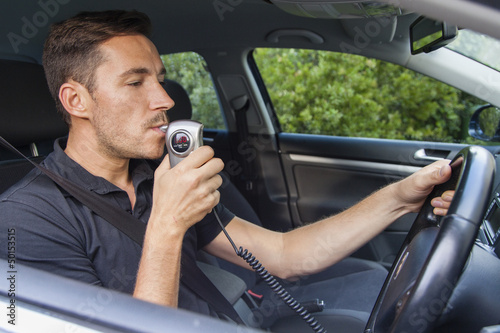 Fotografie Man blowing into breathalyzer