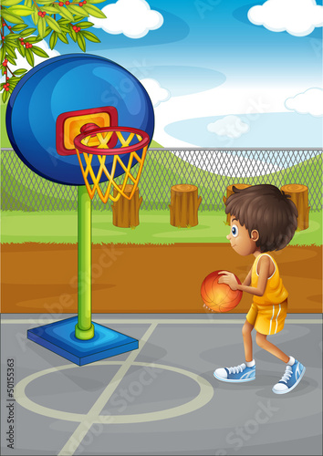 A little boy playing basketball