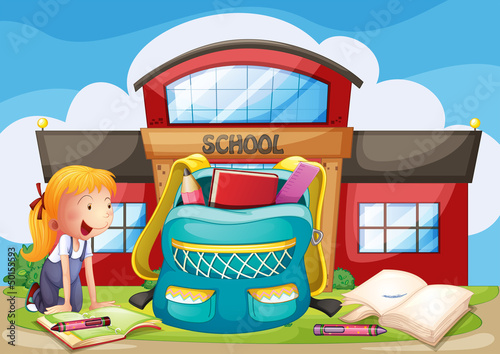 A girl with her school supplies in front of the school building