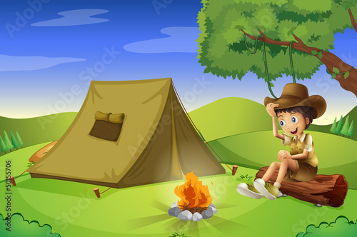 A boy with a tent and a camp fire