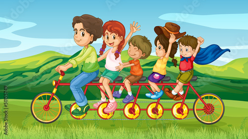 A man riding a bike with four kids