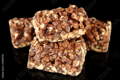 Chocolate sweets with nuts, isolated on black