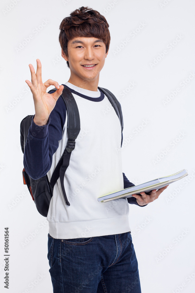 Young Asian stdudent showing okay sign. Young Asian stdudent showing okay sign.