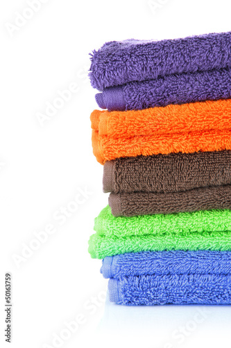 Pile of colorful towels, isolated on white