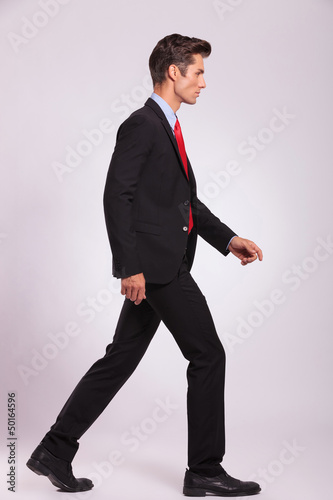 side view of man walking & looking away