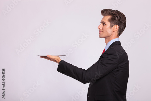 side view of man holding tablet photo