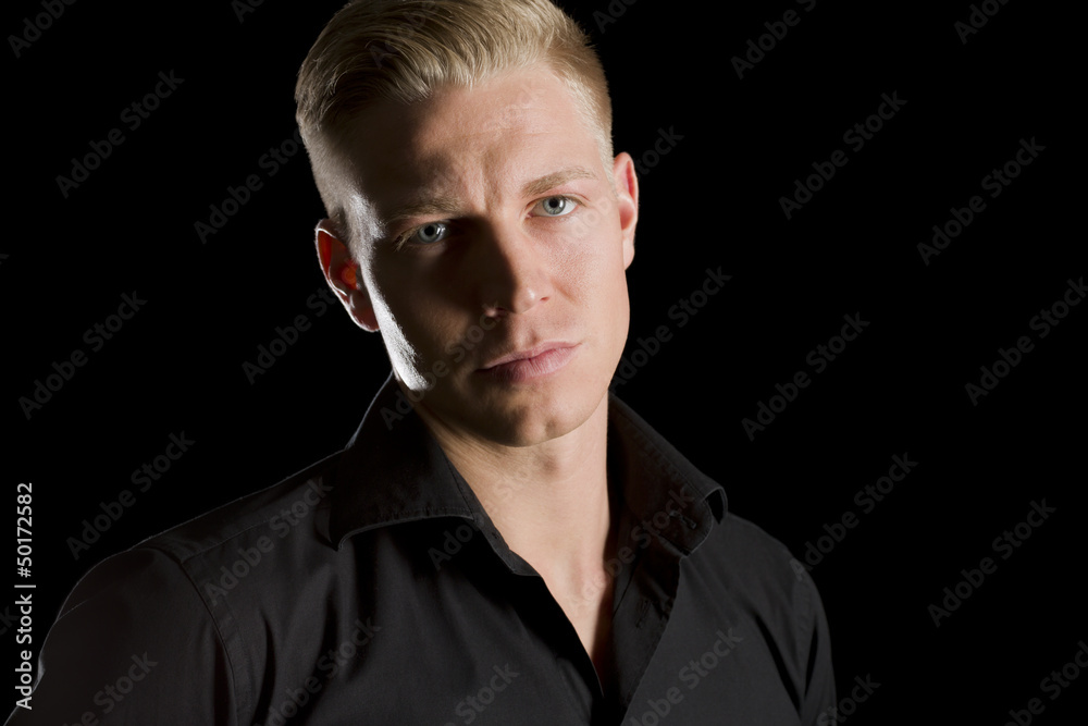 Low key portrait of charming man looking straight. Low key portrait of charming man looking straight.