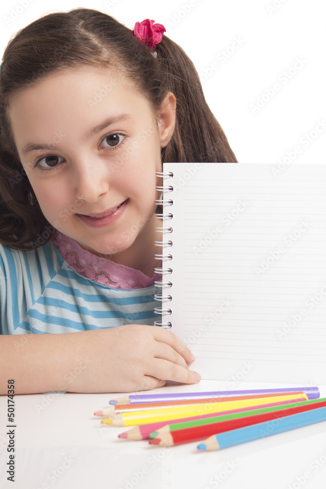 Beautiful little girl showing empty space on notebook Beautiful little girl showing empty space on notebook