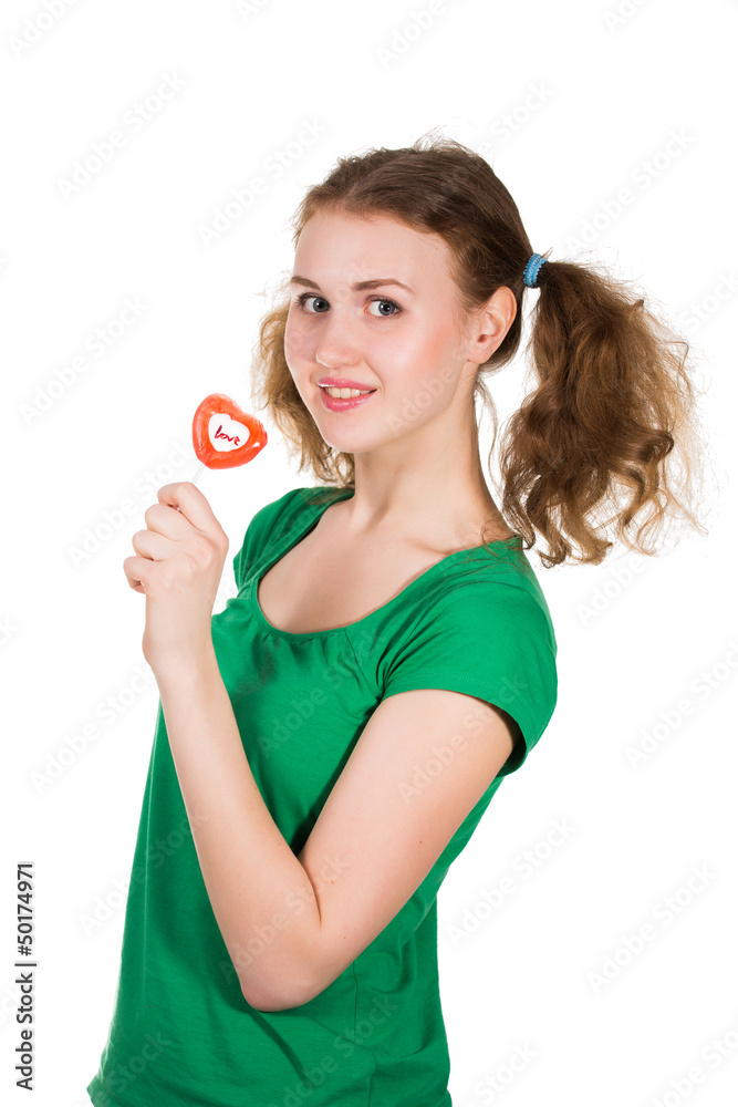 closeup shot of girl with red heart lollipop isolated on white closeup shot of girl with red heart lollipop isolated on white