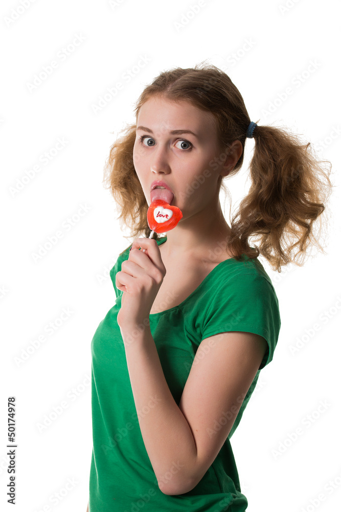 closeup shot of girl with red heart lollipop isolated on white closeup shot of girl with red heart lollipop isolated on white