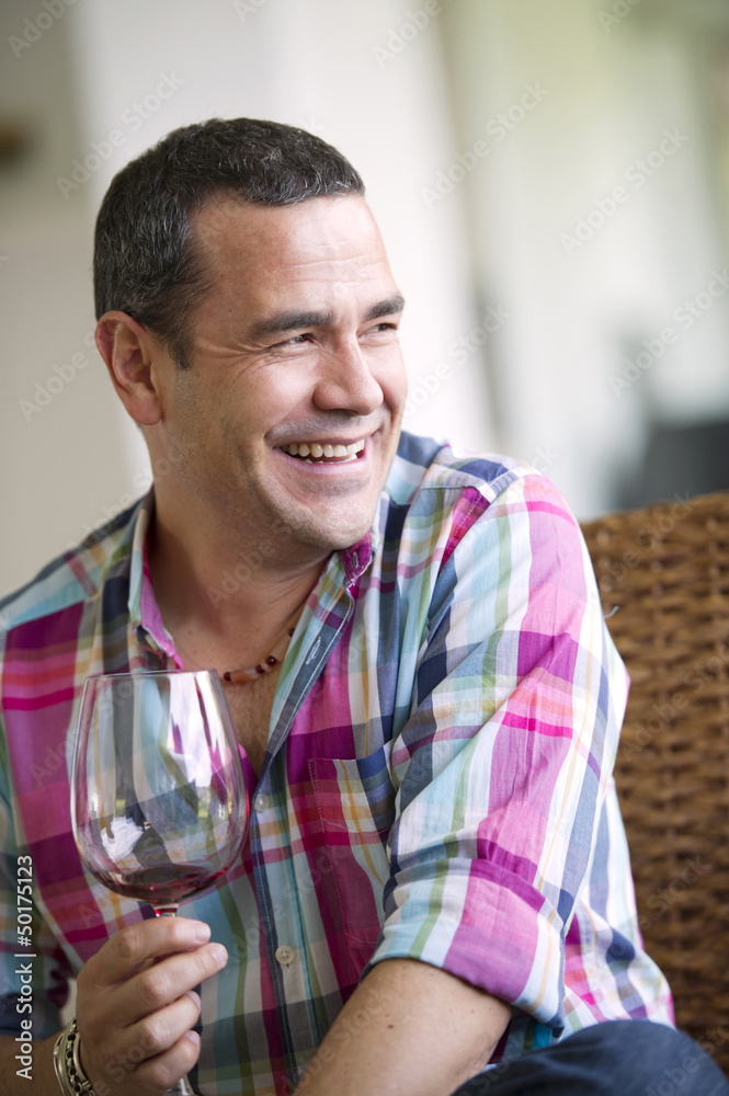 Smiling Hispanic man drinking wine Smiling Hispanic man drinking wine