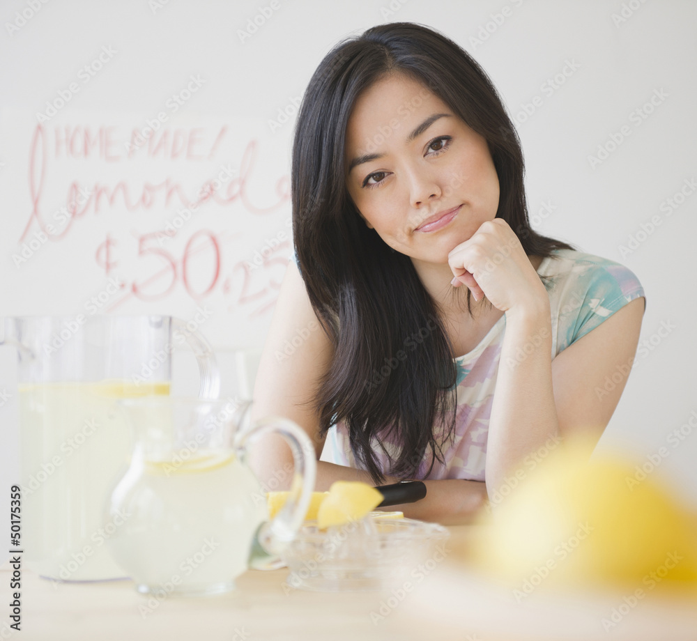 Frustrated Japanese woman sitting at lemonade stand Frustrated Japanese woman sitting at lemonade stand