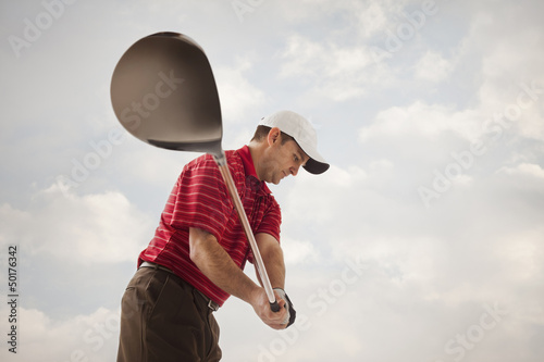 Caucasian golfer swinging golf club