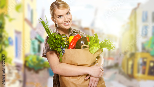 portrait of a middle aged woman carrying a purchase at a crowded