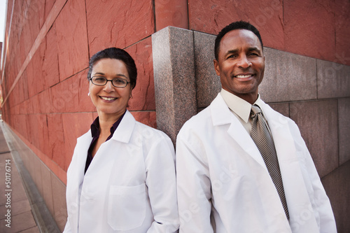Smiling doctors standing outdoors
