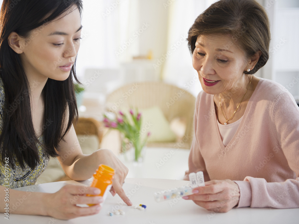 Japanese daughter explaining, medication to mother Japanese daughter explaining, medication to mother