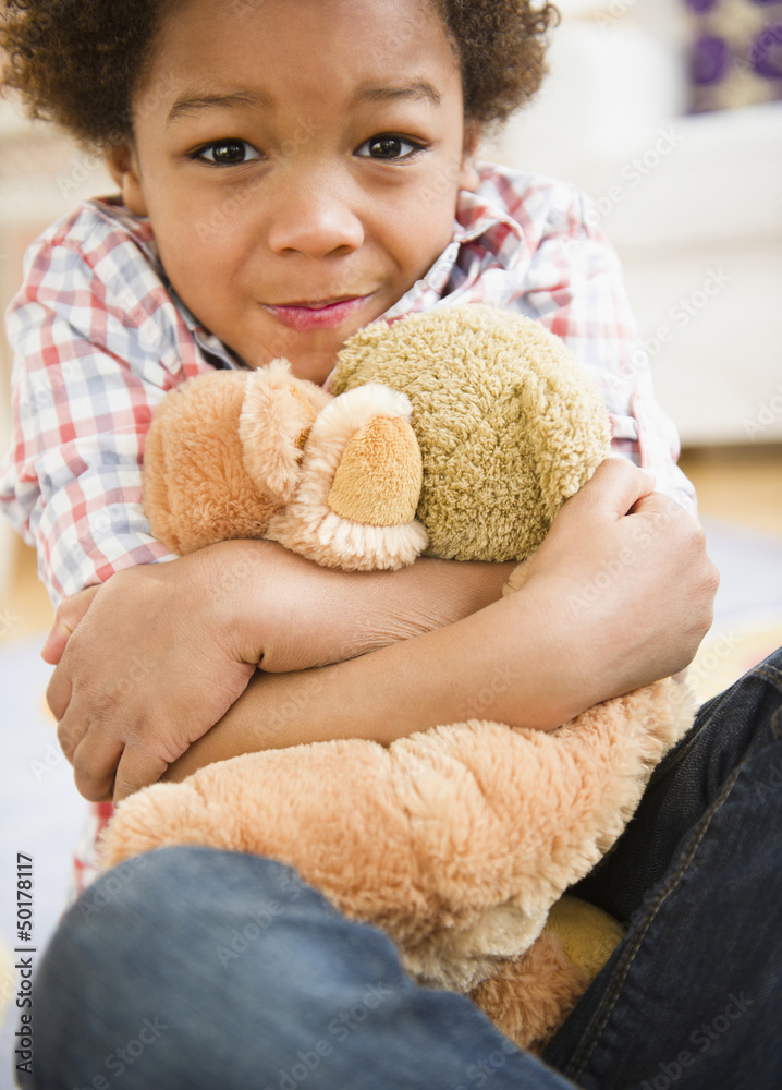 Black boy hugging teddy bear Black boy hugging teddy bear