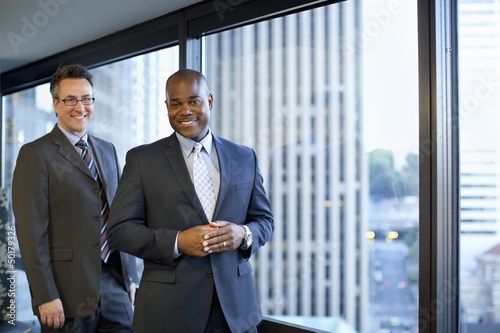 Smiling businessmen standing in office