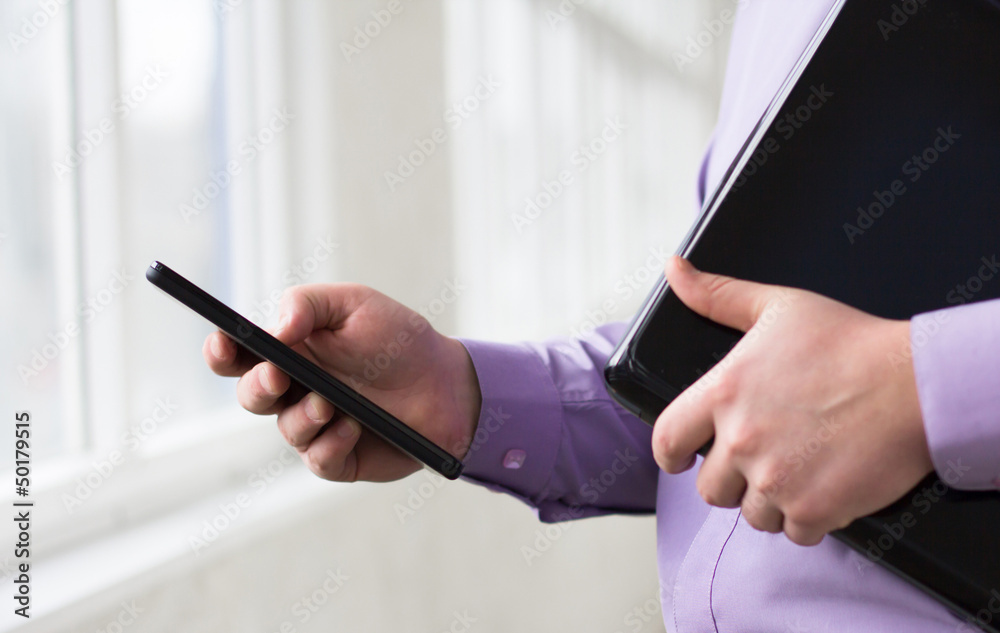 Businessman holding a laptop and Tablet PC