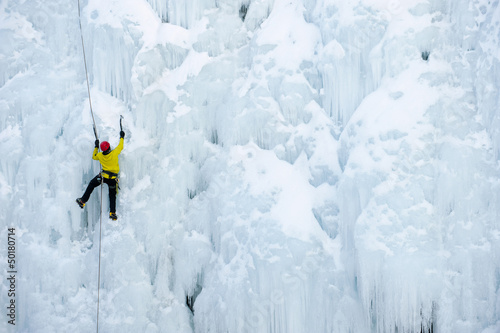 Caucasian man climbing ice