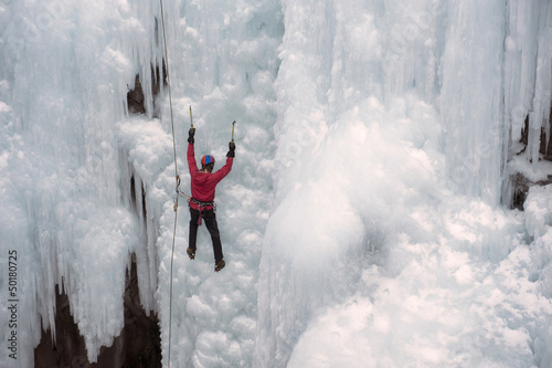 Caucasian man climbing ice