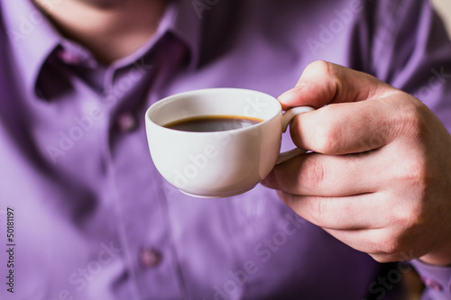A man holding a cup of coffee