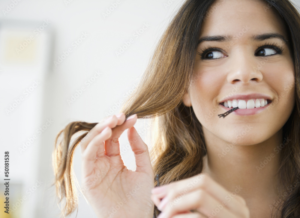 Hispanic woman with bobby pins in her mouth Hispanic woman with bobby pins in her mouth