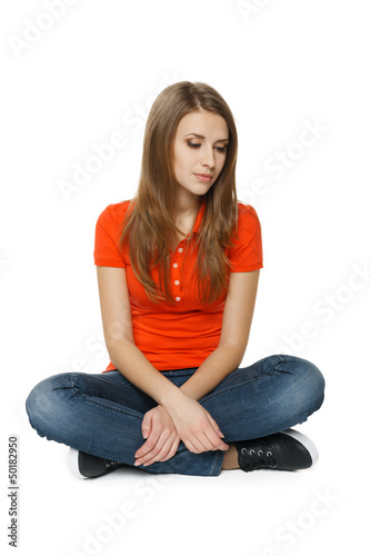 Woman is feeling sad while sitting on the floor