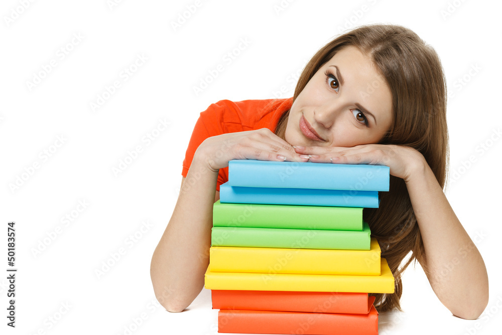 Tired young woman lying on the stack of books Tired young woman lying on the stack of books