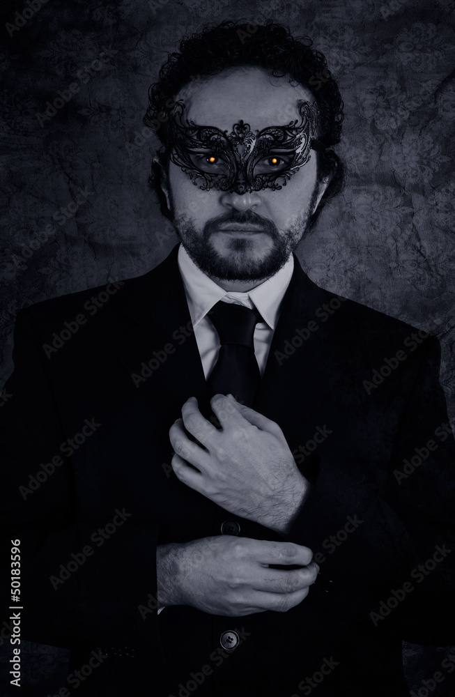 Fototapeta premium Artistic image of vampire masked mystery man and elegant black s