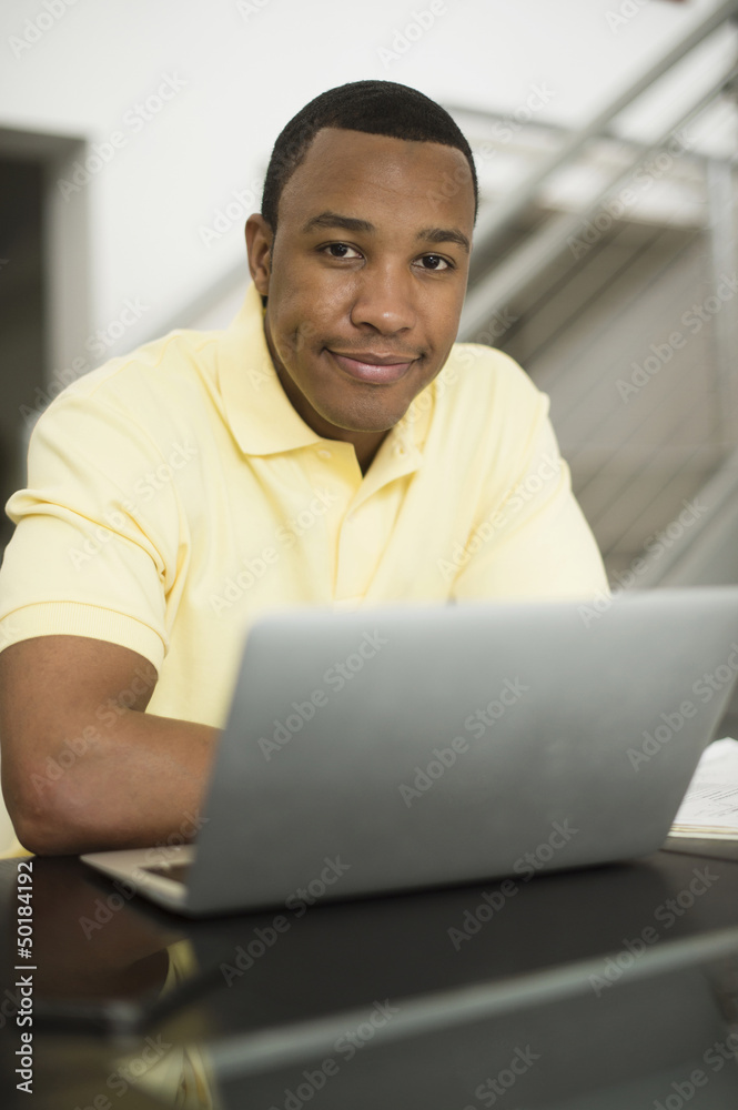 Mixed race businessman using laptop Mixed race businessman using laptop
