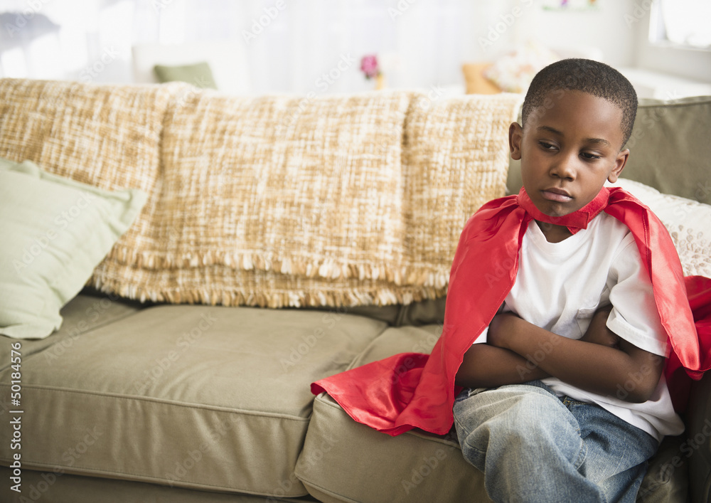 Pouting black boy in superhero cape Pouting black boy in superhero cape