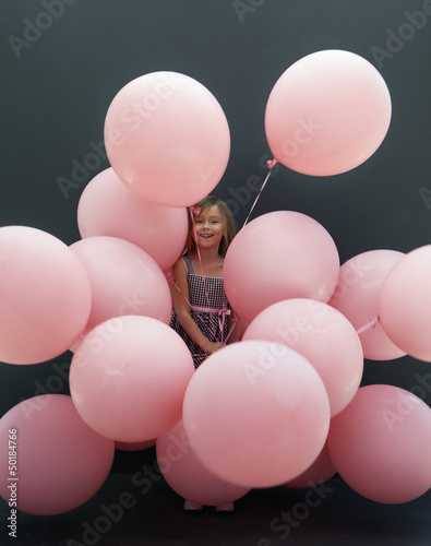 Caucasian girl holding large balloons photo