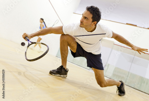 Hispanic couple playing squash photo